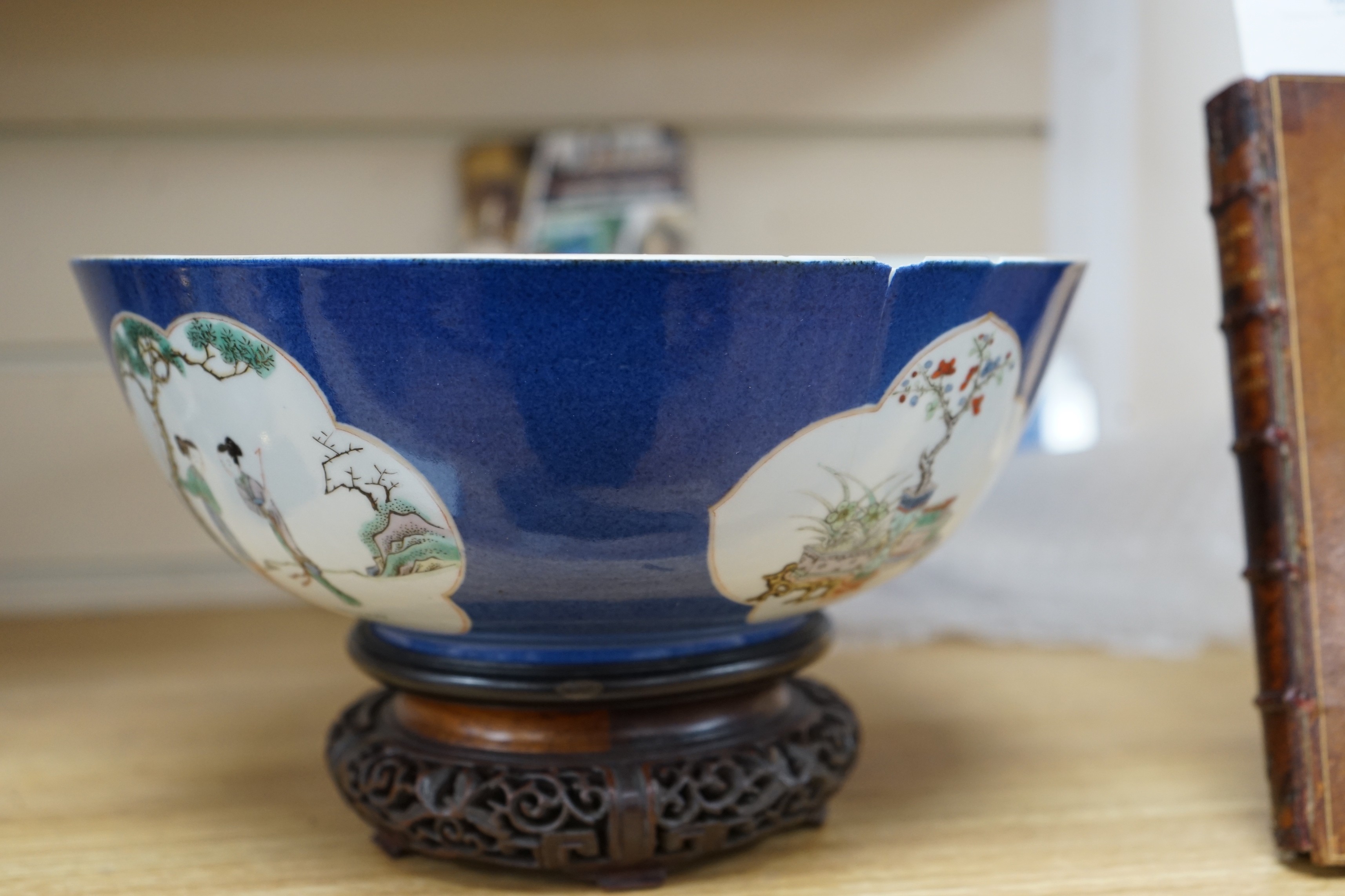 A 19th century Chinese famille verte powder blue bowl, 26cm diameter, wood stand
